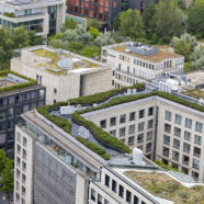 Aerial view of a city with green rooftops